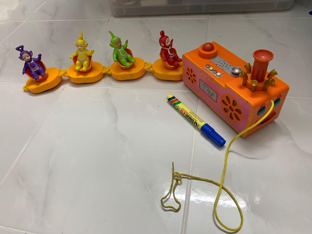 Teletubbies pull shop along custard train