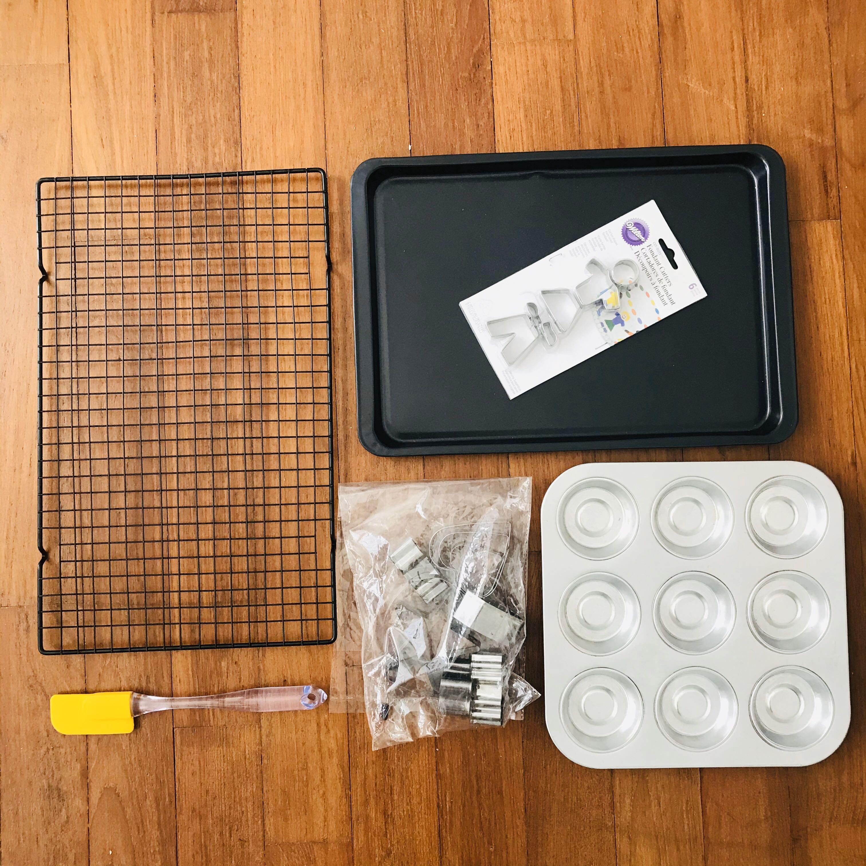 Assorted Bakeware (Category: Bakeware) located in Singapore. Submitted by darrlynn (Listing ID 1106006727, Image 1). Description: Moving out sale: Baking stuff - used once 1. Baking Tray Sheet Pan (25.5cm x 36.5cm), a little dented but does not affect function - $8 2. Cooling Rack (25cm x 40cm) -$8 3. Tart tray (25cm x 25cm) - $8 4. Silicone Spatula Scraper (23cm) - $2 5. Assorted cookie cutters - $4 .
