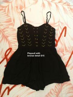 Black playsuit with metallic details on bodice