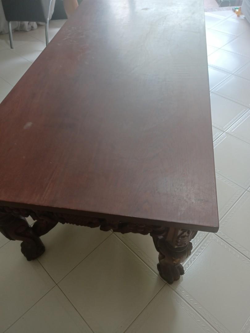 Solid wood coffee table (Category: Tables & Sets) located in Singapore. Submitted by dseow985 (Listing ID 1112947375, Image 2). Description: solid wood and big coffee table....heavy...smooth good quality wood....bought from Indonesia.... beautiful carving on sides and nice base design. Visible slight scratches on table top. length- 150cm width- 73cm height- 56cm Buyer arrange own transport Negotiable.