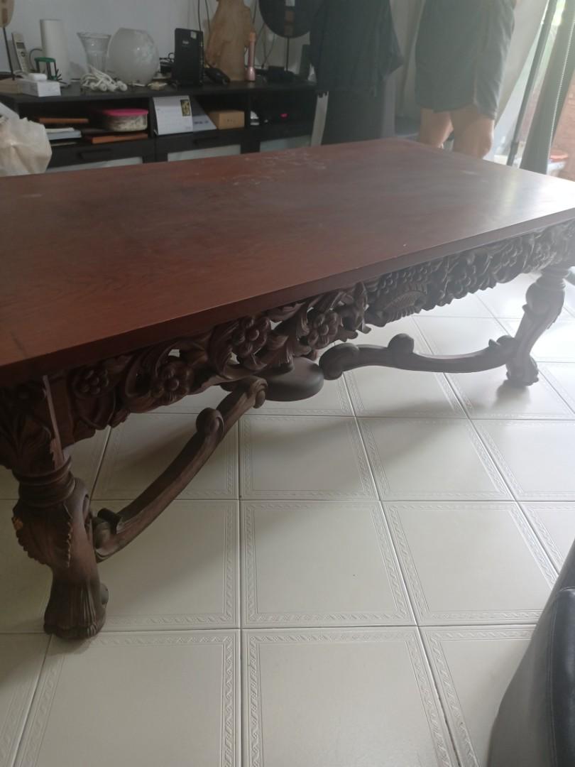 Solid wood coffee table (Category: Tables & Sets) located in Singapore. Submitted by dseow985 (Listing ID 1112947375, Image 1). Description: solid wood and big coffee table....heavy...smooth good quality wood....bought from Indonesia.... beautiful carving on sides and nice base design. Visible slight scratches on table top. length- 150cm width- 73cm height- 56cm Buyer arrange own transport Negotiable.