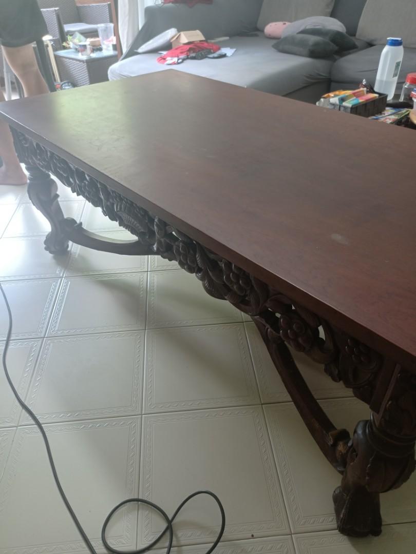 Solid wood coffee table (Category: Tables & Sets) located in Singapore. Submitted by dseow985 (Listing ID 1112947375, Image 3). Description: solid wood and big coffee table....heavy...smooth good quality wood....bought from Indonesia.... beautiful carving on sides and nice base design. Visible slight scratches on table top. length- 150cm width- 73cm height- 56cm Buyer arrange own transport Negotiable.