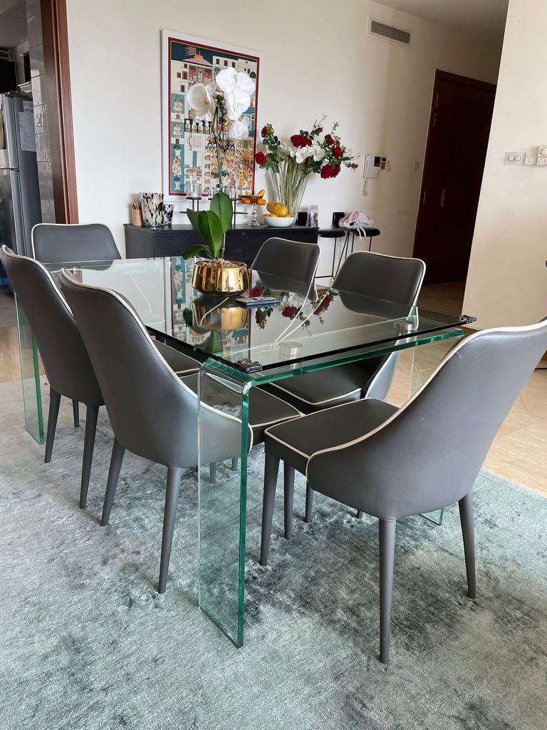 Dining Table (Category: Tables & Sets) located in Singapore. Submitted by suhaniw (Listing ID 1113462194, Image 1). Description: All glass 6 seater dining table size 36” x 72” x 30” ht - $250 | SOLD Chairs are grey faux leather with white piping Chairs available too $40 each Meet up.