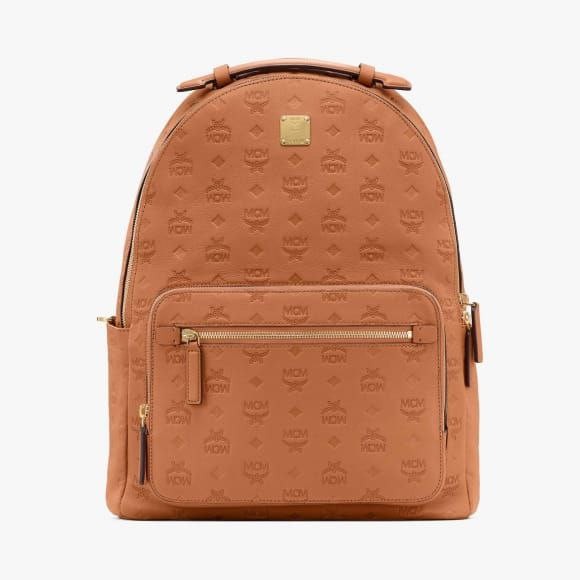 MCM embossed leather mcm backpack medium in cognac Luxury Bags Wallets on Carousell