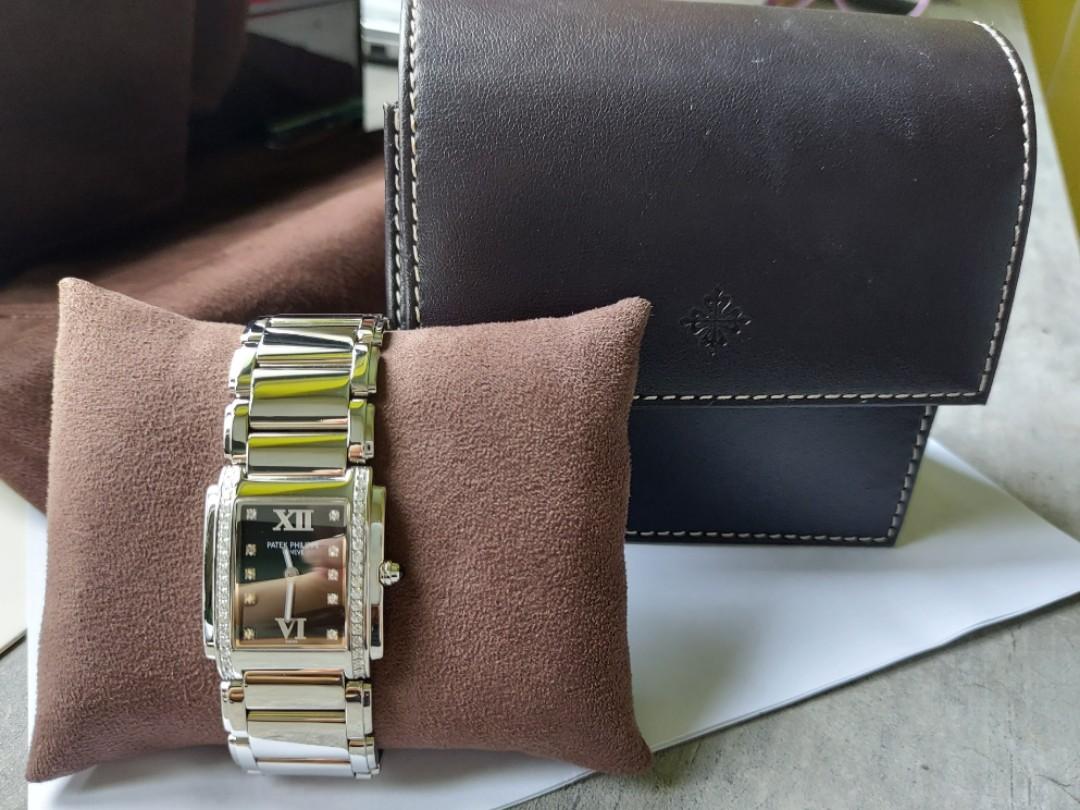 Patek Philippe TWENTY-4 stainless steel Black dial 4910/10A-001 (Category: Watches) located in Singapore. Submitted by dlhz78 (Listing ID 1114957587, Image 3). Description: Patek Philippe TWENTY-4 ladies watch for sale. Full set with cert and receipt. (Dec 2007) Discontinued model; high appreciation value Black dial with roman numeral 10 diamonds on dial markers 36 diamonds on bezel total 0.45 carats quartz movement convenient for ladies stainles