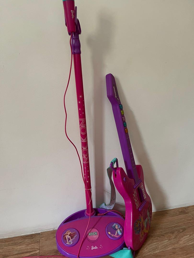 Barbie Guitar and Microphone with stand (Category: Kids Toys) located in Quezon City. Submitted by alen921x (Listing ID 1116284130, Image 2). Description: Bought in Toy Kingdom at 4k (separately) Rfs: outgrown by my daughter No more Would pass as brandnew Can do meet up with SURE buyer Delivery to be shouldered by the buyer.