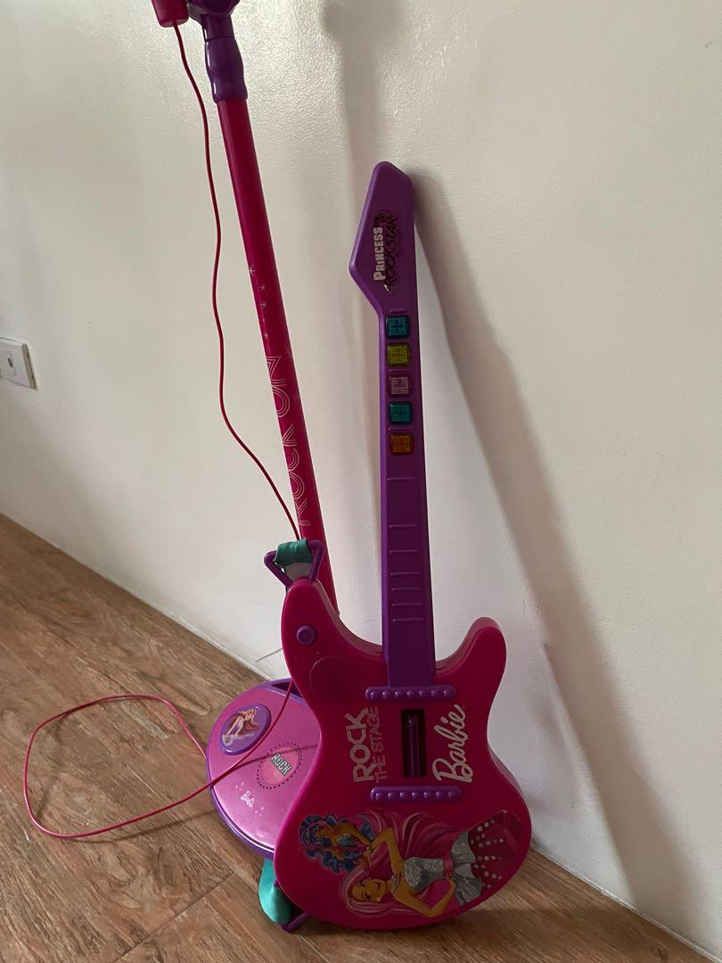 Barbie Guitar and Microphone with stand (Category: Kids Toys) located in Quezon City. Submitted by alen921x (Listing ID 1116284130, Image 3). Description: Bought in Toy Kingdom at 4k (separately) Rfs: outgrown by my daughter No more Would pass as brandnew Can do meet up with SURE buyer Delivery to be shouldered by the buyer.
