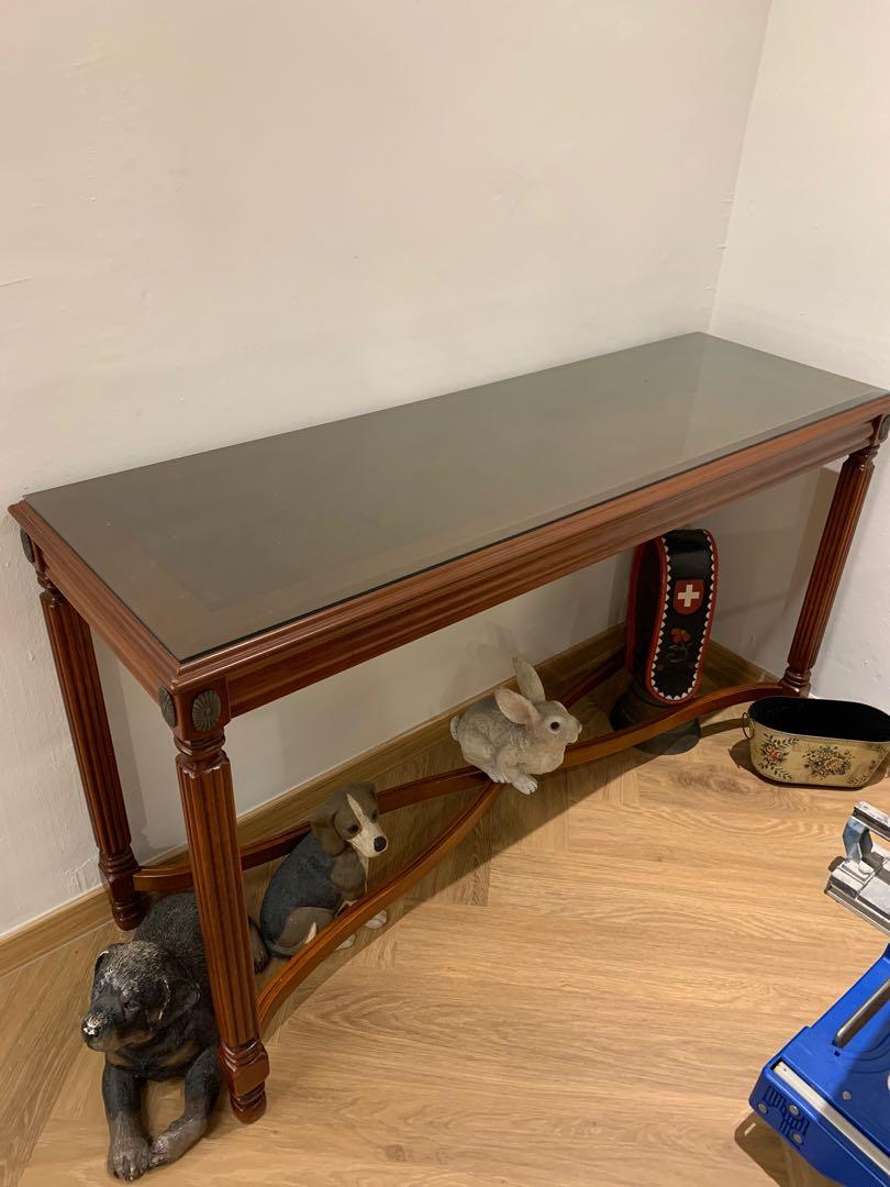 Table (Category: Tables & Sets) located in Singapore. Submitted by ajbabysitting (Listing ID 1112601365, Image 2). Description: A beloved carefully used table with glass top. Rubber wood. Dimension 120x40cm Figurines not included. Only selling table together with glass Please arrange for own pick up..
