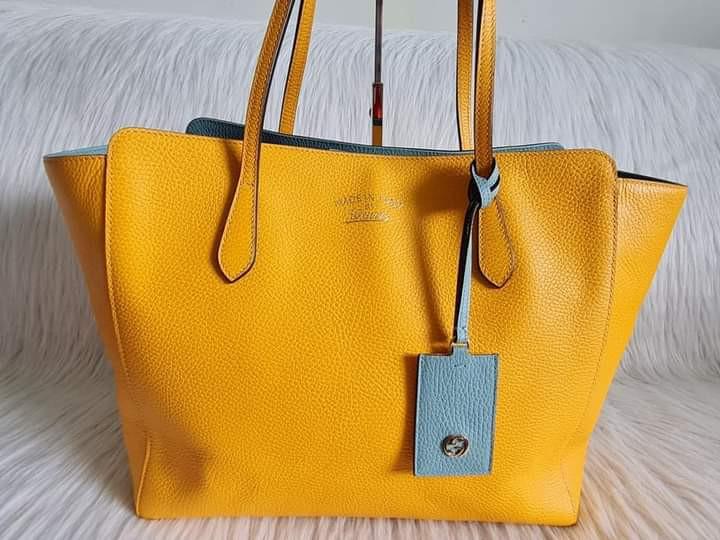 Gucci Medium Swing Tote (Category: Luxury Bags & Wallets) located in Manila. Submitted by bagislifeshop (Listing ID 1137032299, Image 2). Description: ▪️ Gucci medium swing tote▪️ ☑️In transit to Manila ✅Colour: Yellow exterior and light blue interior ✅Condition: 8.5/10 ✅Inclusions: clochette and cards.