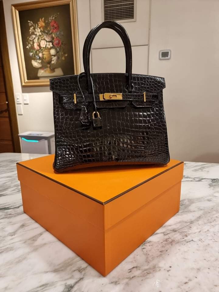 It's not a bag. It's a Birkin ✨ Crafted in glossy black porosus crocodile  with gold plated hardware, this truly stunning Hermes 'Birkin 30'…