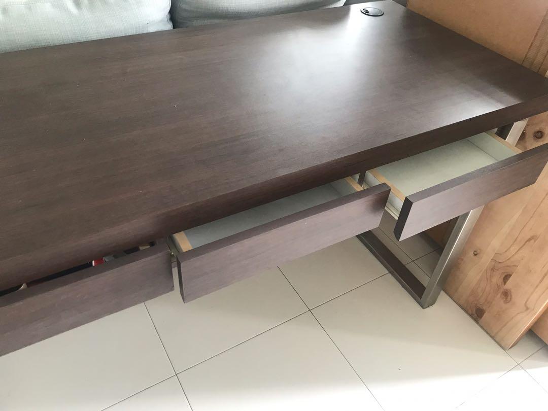 Custom-made study table (Category: Tables & Sets) located in Singapore. Submitted by winniehpl (Listing ID 1137813316, Image 3). Description: 148cm wide x 61cm deep, custom-made with solid wood and dark wood grain lamination. One side stainless steel leg. Fully laminated front and back. 3 built in drawers. Lightly used condition, no dents. Clearing cos down-sizing & won’t need such a big desk. Self collect fr telok blangah..
