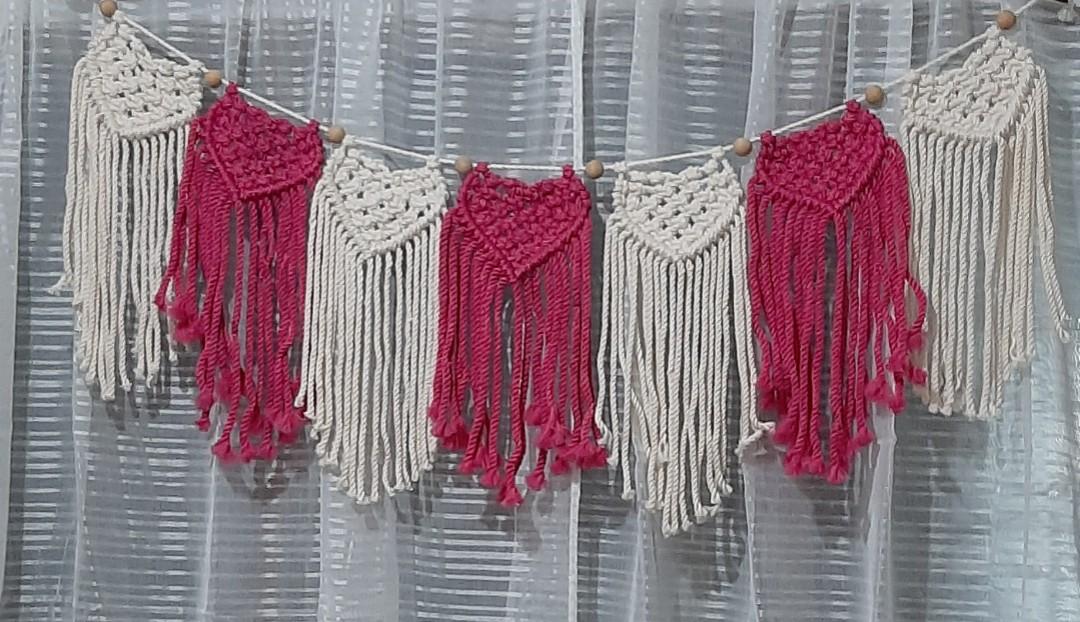 Macrame heart bunting (Category: Wall Decor) located in Binan City. Submitted by relizas_modern_macrame (Listing ID 1138546416, Image 1). Description: available best for valentine events home or room decoration 14x38cm size per bunting 180pesos per bunting creamy white and fuschia pink on the photo.