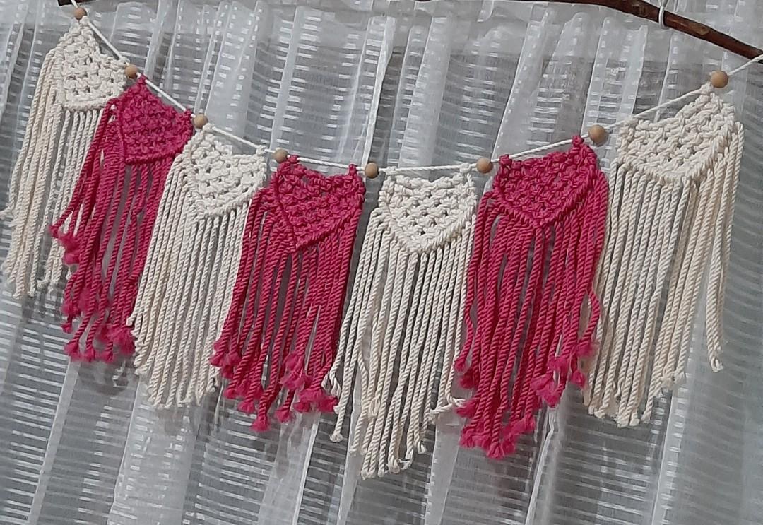 Macrame heart bunting (Category: Wall Decor) located in Binan City. Submitted by relizas_modern_macrame (Listing ID 1138546416, Image 2). Description: available best for valentine events home or room decoration 14x38cm size per bunting 180pesos per bunting creamy white and fuschia pink on the photo.