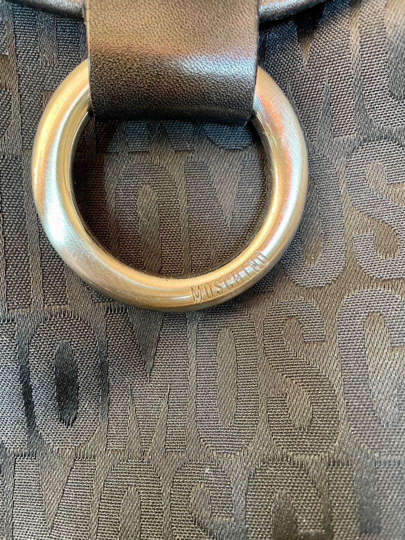 Moschino Mono Shoulder Bag (Category: Luxury Bags & Wallets) located in Muntinlupa City. Submitted by phbudgetluxuryfinds (Listing ID 1138990258, Image 2). Description: With Original dustbag Excellent Condition - still feels new Authentic✅✅✅ Texture is comparable to Fendi Zucca.