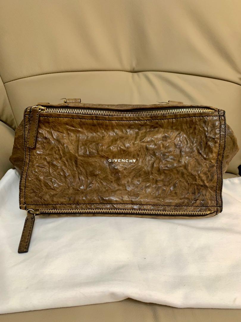 Givenchy Pandora Medium (Category: Luxury Bags & Wallets) located in Paranaque City. Submitted by listitwithb (Listing ID 1135085997, Image 1). Description: GIVENCHY Walnut Brown Textured Leather PANDORA Convertible Shoulder Bag This is the "Pandora" convertible shoulder bag by Givenchy. This bag is a convertible design with one rolled leather top handle and one detachable flat leather strap. It has two exterior zip pockets and one interior zip p