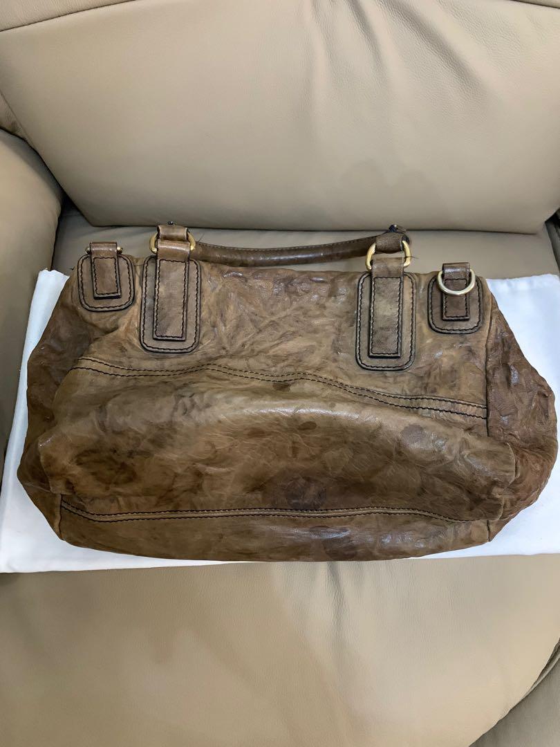 Givenchy Pandora Medium (Category: Luxury Bags & Wallets) located in Paranaque City. Submitted by listitwithb (Listing ID 1135085997, Image 2). Description: GIVENCHY Walnut Brown Textured Leather PANDORA Convertible Shoulder Bag This is the "Pandora" convertible shoulder bag by Givenchy. This bag is a convertible design with one rolled leather top handle and one detachable flat leather strap. It has two exterior zip pockets and one interior zip p