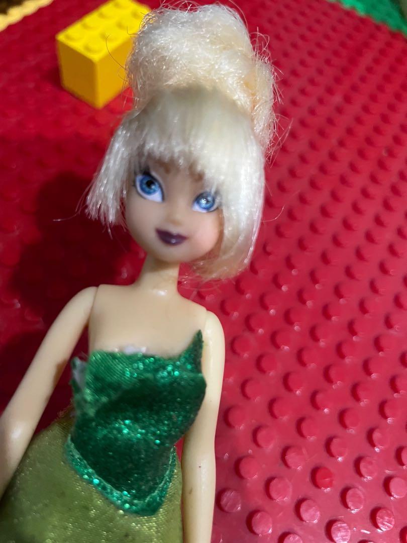Disney Tinkerbell Doll (tiny) (Category: Figurines & Statues) located in Carmona. Submitted by thepinkplayhouse (Listing ID 1140972945, Image 2). Description: Item: Disney Tinkerbell | wearing her original clothes Size: 5.5 inches Note: Tinkerbell has no shoes in the movie. She is sold without shoes in stores. Made by Disney. Just needs minimal washing and cleaning. .