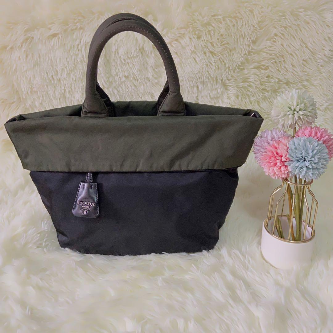 Prada Tessuto Reversible Tote Bag (Category: Luxury Bags & Wallets) located in Las Pinas. Submitted by Le.Pattie.Luxe (Listing ID 1136012174, Image 1). Description: Authentic Small Prada Tessuto Reversible Tote Bag 🖤Php 12,000🖤 Colors: black & army green Reversible to slightly discolored army green With Prada bag charm, 2 zip pockets & Prada metal triangle logo on the side With d-rings for strap No inclusion Approx size: 11-16 x 9.5 x 7in (LxHx