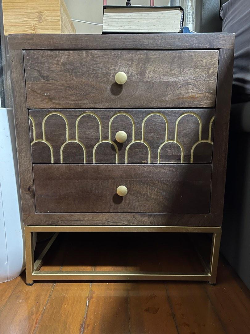 Classy Bed Side Table (Solid Wood) (Category: Tables & Sets) located in Singapore. Submitted by hiroshee (Listing ID 1189838995, Image 3). Description: - A pair of classic Solid Wood Bedside table with 3 drawers each - Classic Gold detailing on the drawers - Gold Metal base leg - Stained wood design - Vintage classic furniture - Selling as a pair - Purchased from Italy at $299 each ($598) - Selling at $200 for both - Selling due to relocation - S