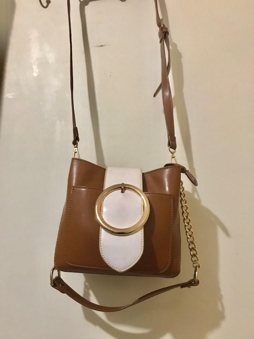 Shoulder bag (Category: Shoulder Bags) located in Pasig City. Submitted by hanjeongsik (Listing ID 1191086731, Image 2). Description: **PLEASE READ** > Color: White, Brown, Gold > Hardware: sobrang shiny pa rin > Inner: divider, 1 open pocket, 1 zipped pocket, no flaws > Zipper: working just fine > Closure: Magnetic clasp > Short strap: New, perfect condition > Long strap: Flawed see photo Kindly check each photo for minor flaws and please manage