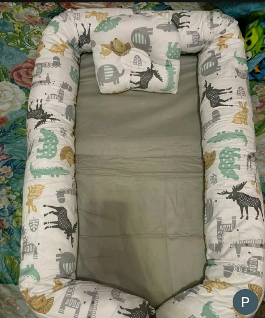 Baby Crib nest with pillow (Category: Cots & Cribs) located in Marilao. Submitted by majoriety (Listing ID 1191253396, Image 1). Description: di po nagamit yun pillow & bed blanket (used) animal print 80×50cm kakabili lng, mas gusto ni baby sa duyan gcash shapee chec k out https://shope.ee/408NYanEpt.