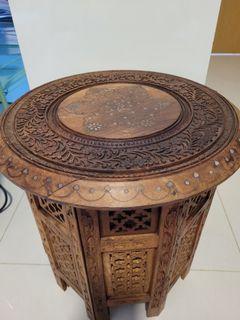 Solid wood, hand-carved side table