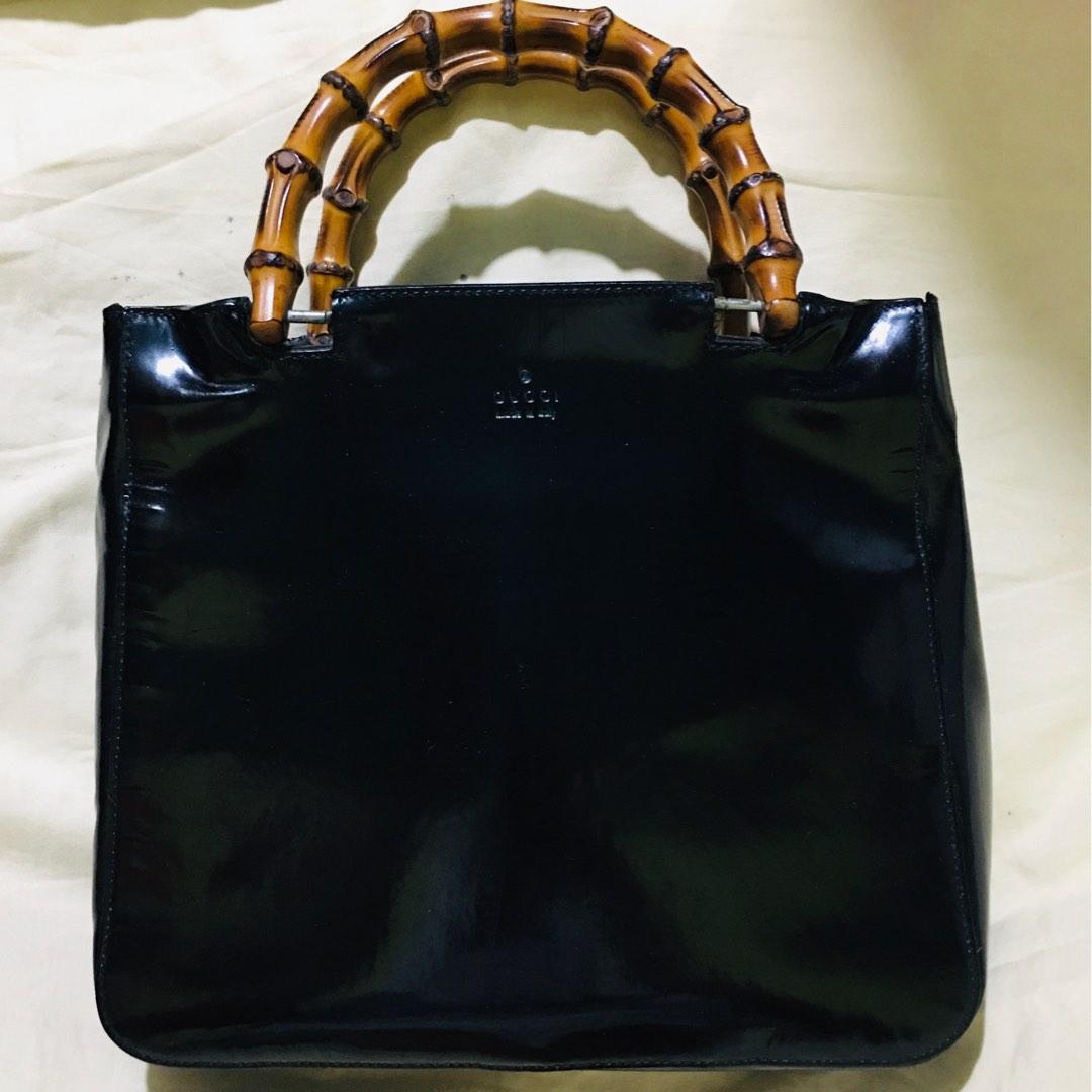 Authentic Gucci patent leather bamboo handle bag (Category: Luxury Bags & Wallets) located in Donsol. Submitted by saksthriftavenuebyluckymaria8 (Listing ID 1193035163, Image 3). Description: 10in length x 9in height x 3in width Handle drop 3 in Well used condition Side part with deformation 1 zipped pocket Open tote bag Made in Italy With serial code .