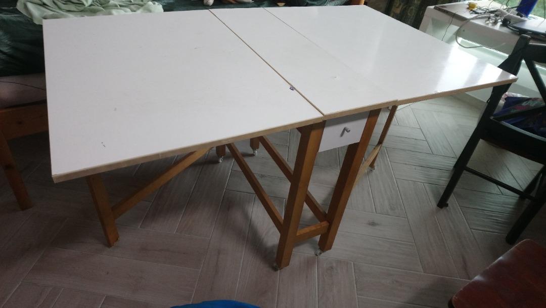 Space Saving multi purpose Folding Table (Category: Tables & Sets) located in Singapore. Submitted by dolphin195 (Listing ID 1188450021, Image 1). Description: Folding table that can be used as study or dining or multi purpose. Breadth 33 n half inch, n if open one side 33 inch, height 30inch with wheel Space Saving and Opens on either side with 2 drawers in the centre. I have fixed small wheels to the table for easy moving around the house(1 of 