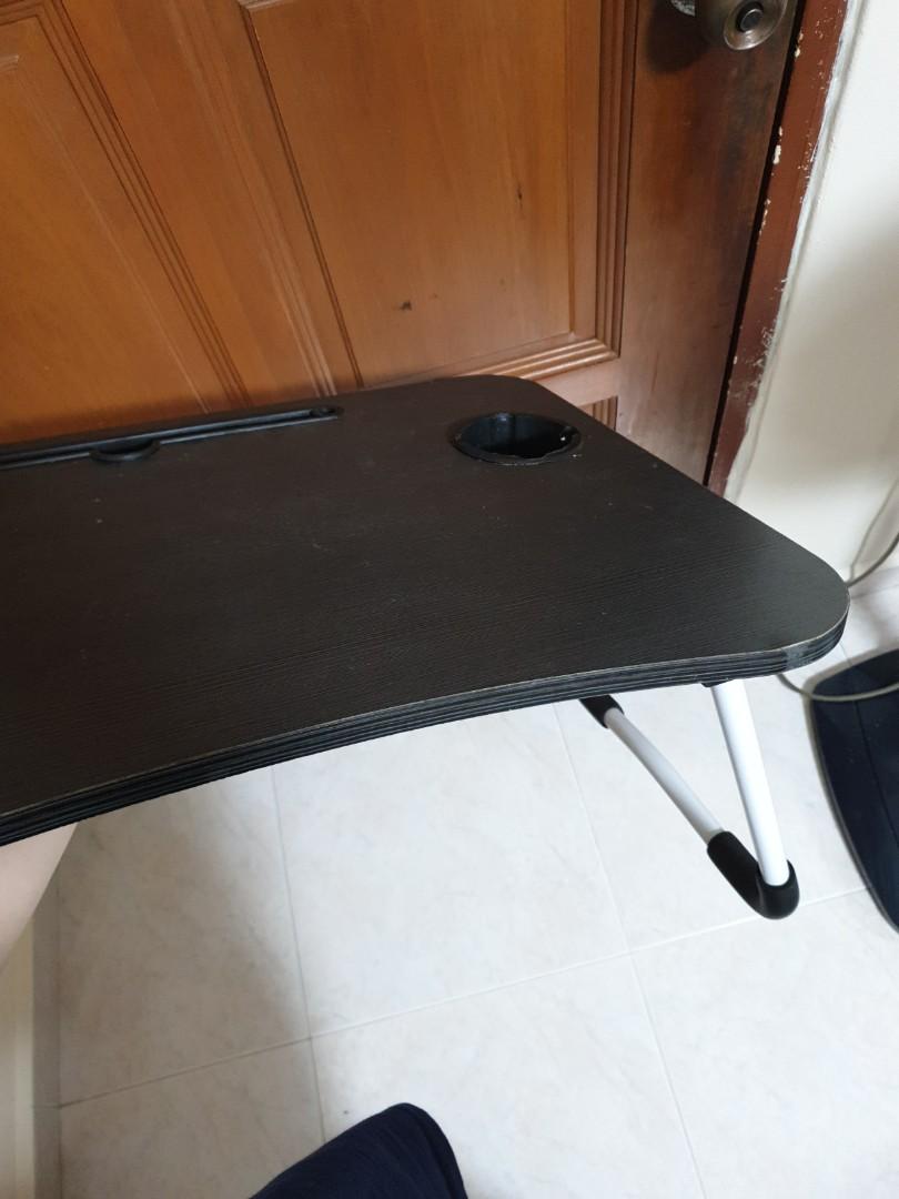 Foldable bed table (Category: Tables & Sets) located in Singapore. Submitted by crovetteofficial (Listing ID 1189629083, Image 3). Description: Foldable table complete with cup holder and ipad stand so that u can enjoy your Netflix and starbucks on your bed comfortably. Table legs have padding so it won't slip. very sturdy. 10/10 would recommend.