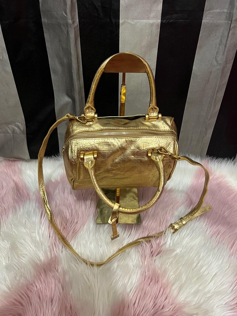 Defaye Black in gold leather with sling (Category: Luxury Bags & Wallets) located in Cebu City. Submitted by shofaholicz (Listing ID 1194075655, Image 2). Description: Very pretty in actual / rare gold color / amooth zipper and magnetic snap pocket.