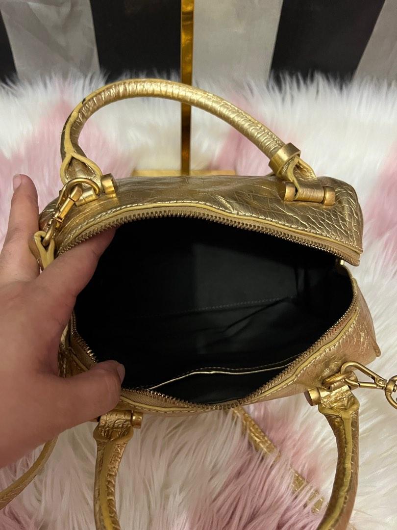 Defaye Black in gold leather with sling (Category: Luxury Bags & Wallets) located in Cebu City. Submitted by shofaholicz (Listing ID 1194075655, Image 3). Description: Very pretty in actual / rare gold color / amooth zipper and magnetic snap pocket.