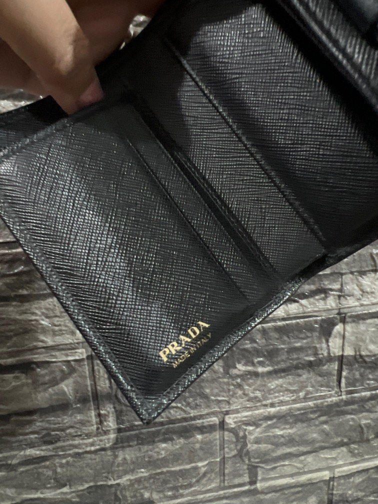 Prada Saffiano Small Fiocco Bow Wallet (Category: Luxury Bags & Wallets) located in Paranaque City. Submitted by sillybella (Listing ID 1195954605, Image 3). Description: Lower Shipping fee check out c/o orange app Japan Bought 100% legit Prada Saffiano Small Fiocco Bow Wallet Color: Nero / Black No inclusion selling low Exterior: Edge wear Hardware: minor Scratch(es) / fading Interior: normal surface wear Length: 4.75 in Width: 0.75 in Height: 3