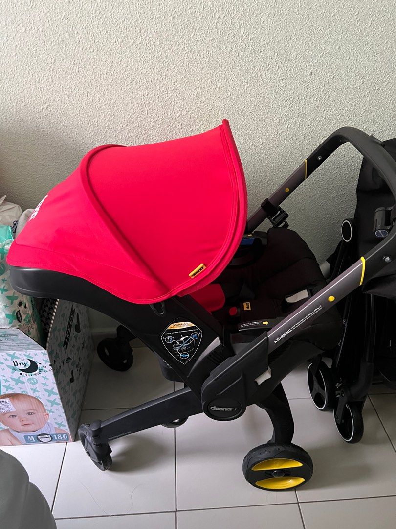 Red doona car seat shop
