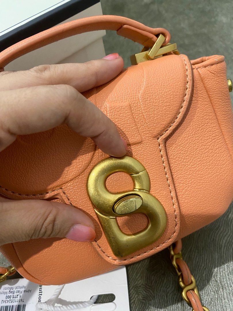 Our micro Alma Flap Bag in apricot and rose is a true statement