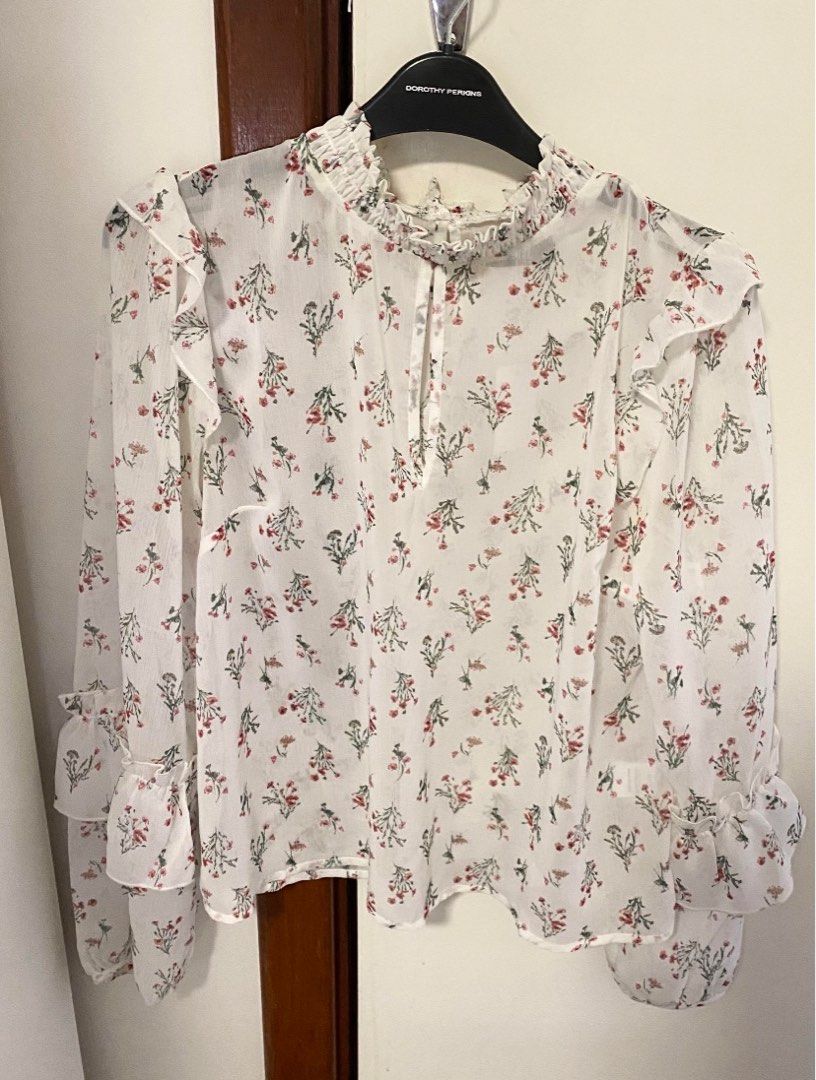 Floral blouse with frill detail (Category: Women's Clothes) located in Perth. Submitted by jazselling (Listing ID 1196456327, Image 1). Description: Has frills around collar & on sleeves Buttons up at the back BNWT never worn , excellent condition Labeled size 10 - will fit AU 6 to AU 8.