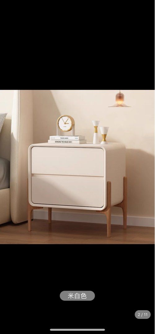 Bedside table (Category: Shelves, Cabinets & Racks) located in Singapore. Submitted by blessedtulip (Listing ID 1197723916, Image 1). Description: Brand new, just arrived. Faux leather off white colour. 35cm x 40cm x 50cm Arrange self pick up. 2 drawers with soft closing. Need to drill the 4 wooden legs (have yet to do it, still in bag brand new).