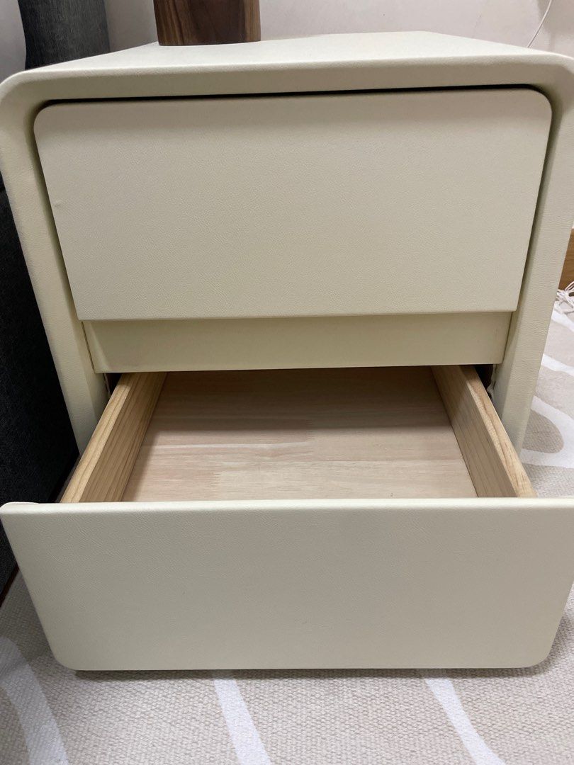 Bedside table (Category: Shelves, Cabinets & Racks) located in Singapore. Submitted by blessedtulip (Listing ID 1197723916, Image 3). Description: Brand new, just arrived. Faux leather off white colour. 35cm x 40cm x 50cm Arrange self pick up. 2 drawers with soft closing. Need to drill the 4 wooden legs (have yet to do it, still in bag brand new).