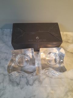 A pair of glass candle holder
