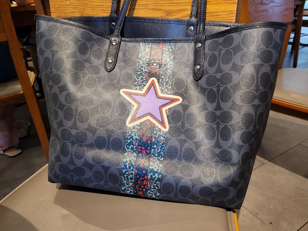 Coach reversible city shopper tote (Category: Purses & Pouches) located in Caloocan City. Submitted by starbucksph (Listing ID 1197883273, Image 2). Description: authentic COACH shopper tote pvc body leather handles signs of wear Add a pop of personality to your everyday ensembles with this chic tote featuring a vibrant star appliqué and ample space for all of your necessities. 18.5'' W x 11.5'' H x 6'' D 10'' shoulder drop Signature coated canva