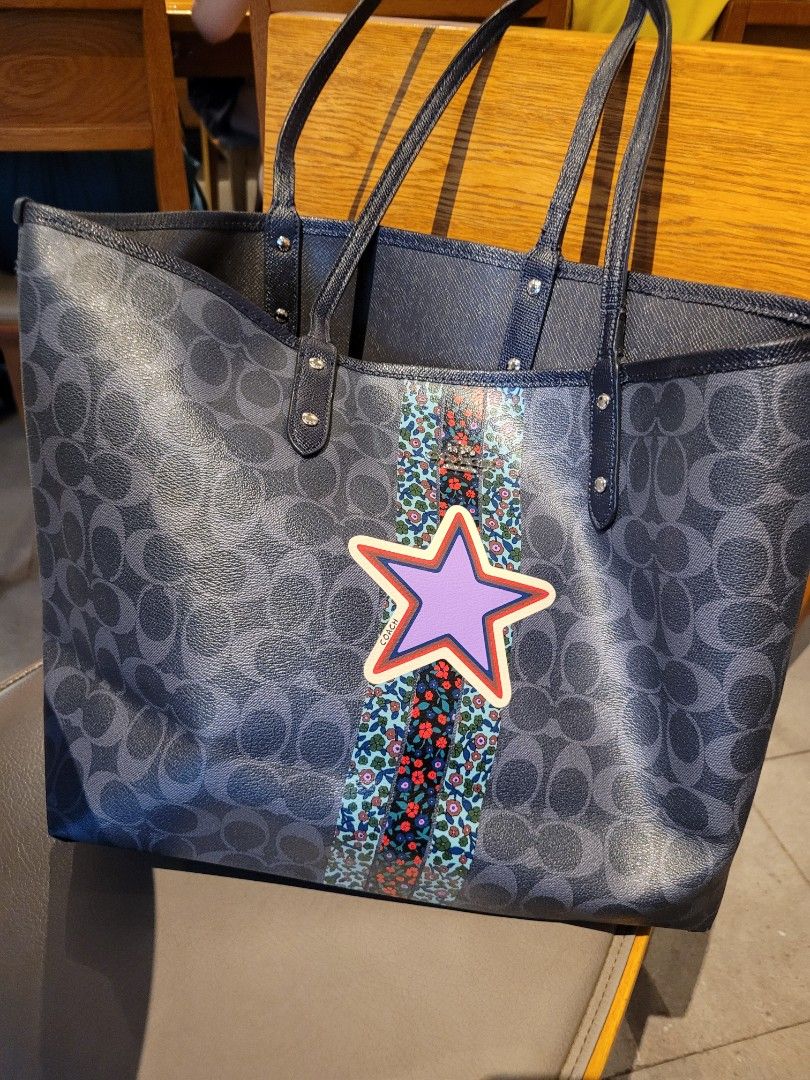 Coach reversible city shopper tote (Category: Purses & Pouches) located in Caloocan City. Submitted by starbucksph (Listing ID 1197883273, Image 1). Description: authentic COACH shopper tote pvc body leather handles signs of wear Add a pop of personality to your everyday ensembles with this chic tote featuring a vibrant star appliqué and ample space for all of your necessities. 18.5'' W x 11.5'' H x 6'' D 10'' shoulder drop Signature coated canva