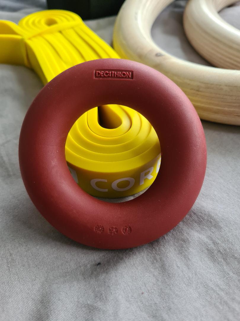 Decathlon rings, yellow resistance band and finger strength trainer