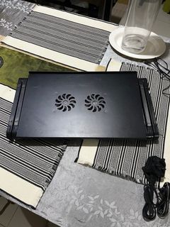 Adjustable laptop table with cooling fan