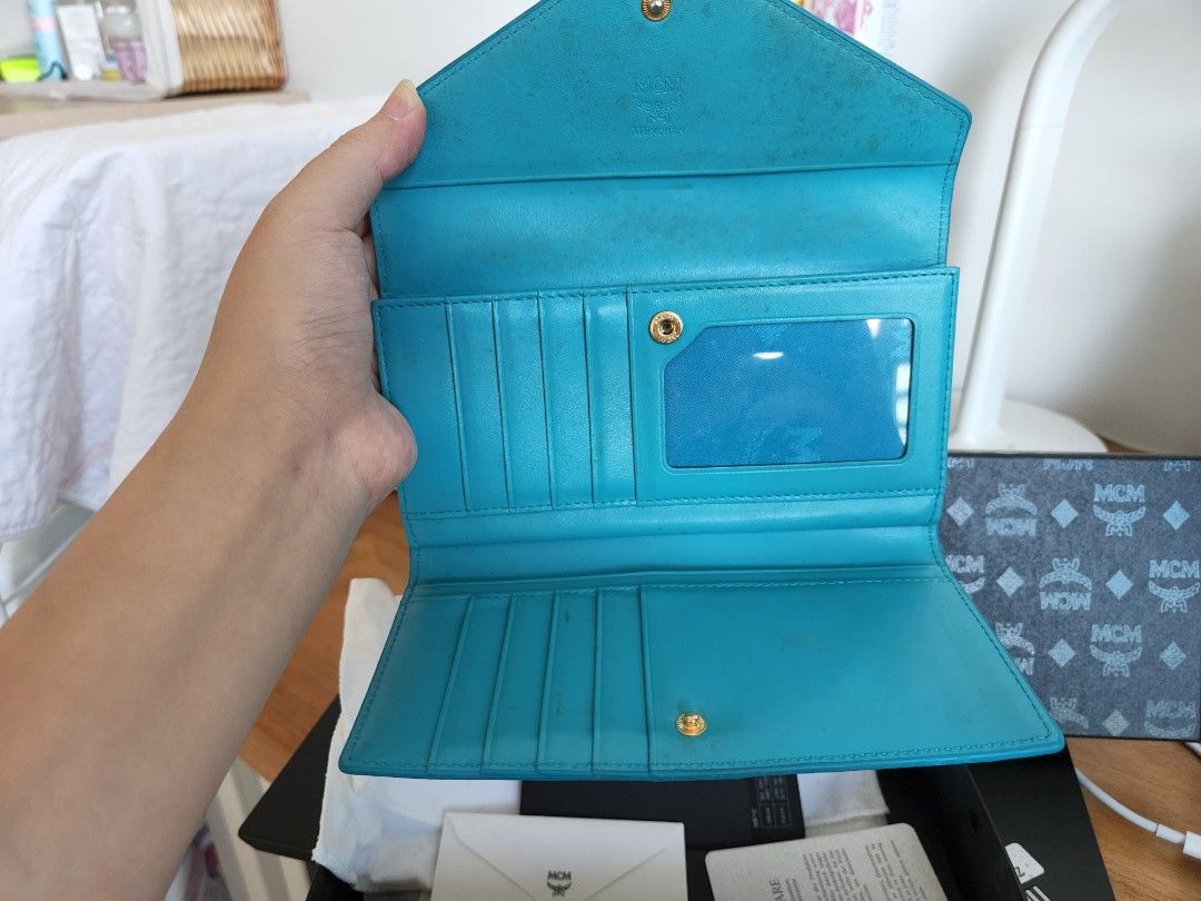 MCM long wallet blue. Box bag dust bag cards (Category: Bags & Wallets) located in Singapore. Submitted by hatsuyuki26 (Listing ID 1198329672, Image 3). Description: Well used MCM wallet Will need some cleaning Comes with full set of bag, box, dust bag, cards 100% authethic Free courier or meet up.