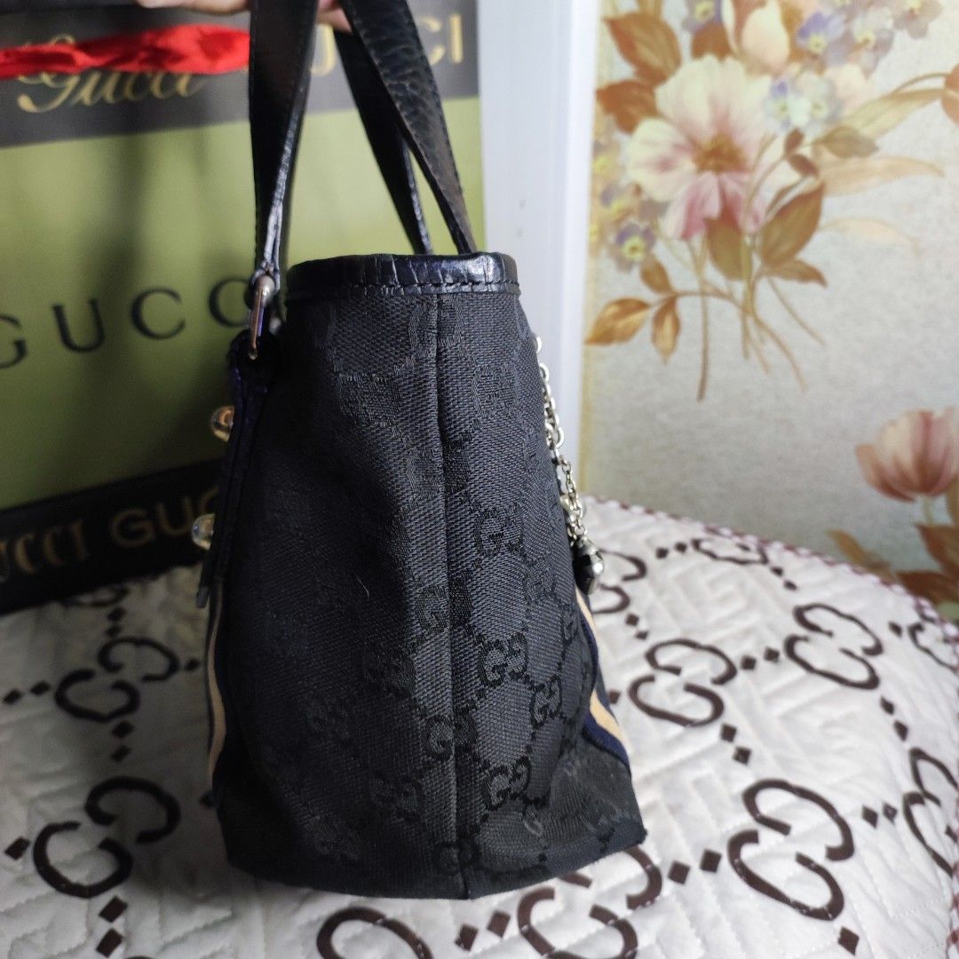 🇯🇵GG Mini Tote (Category: Luxury Bags & Wallets) located in Santa Rosa. Submitted by yerbua103 (Listing ID 1198658779, Image 2). Description: 👛This a classic Gucci's monogram with its black exterior canvas and leather handles. this bag features dual handles and gold toned hardwares, 2 charms from one of the handles - a classic Gucci Horsebit Bag and a classic Gucci boot accentuates the bag. Interior is a black lining with a zip pocket and a sl