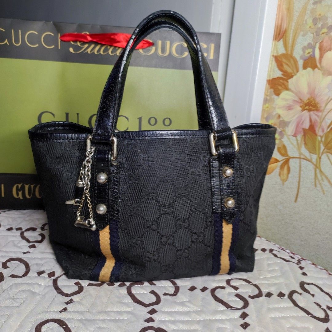 🇯🇵GG Mini Tote (Category: Luxury Bags & Wallets) located in Santa Rosa. Submitted by yerbua103 (Listing ID 1198658779, Image 1). Description: 👛This a classic Gucci's monogram with its black exterior canvas and leather handles. this bag features dual handles and gold toned hardwares, 2 charms from one of the handles - a classic Gucci Horsebit Bag and a classic Gucci boot accentuates the bag. Interior is a black lining with a zip pocket and a sl