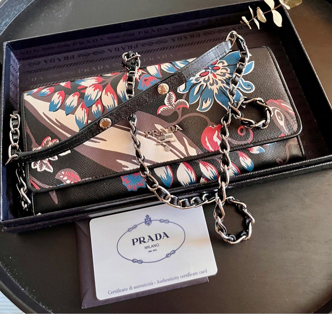 Prada Wallet on chain (Category: Luxury Bags & Wallets) located in Makati City. Submitted by shop.y5 (Listing ID 1198561943, Image 2). Description: Authentic Prada wallet on chain - in very good condition -Barely used -with authenticity card -minor sign of usage.