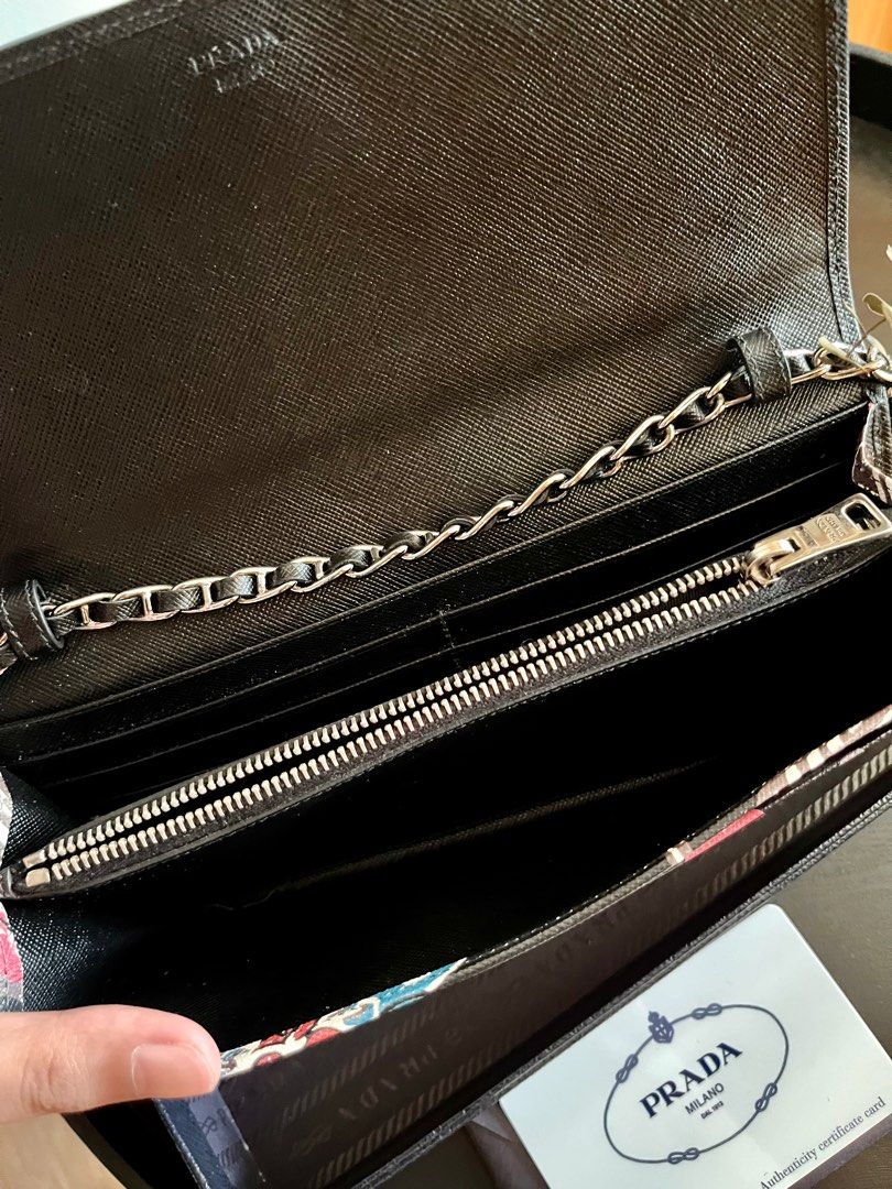 Prada Wallet on chain (Category: Luxury Bags & Wallets) located in Makati City. Submitted by shop.y5 (Listing ID 1198561943, Image 3). Description: Authentic Prada wallet on chain - in very good condition -Barely used -with authenticity card -minor sign of usage.