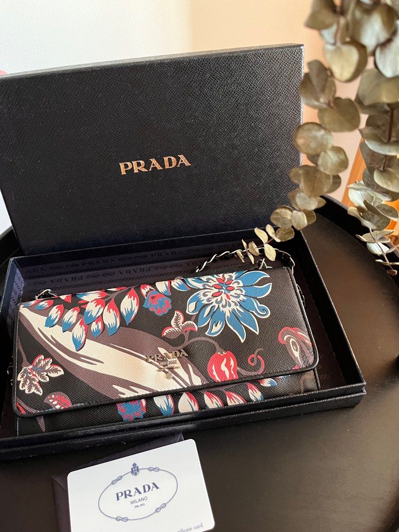 Prada Wallet on chain (Category: Luxury Bags & Wallets) located in Makati City. Submitted by shop.y5 (Listing ID 1198561943, Image 1). Description: Authentic Prada wallet on chain - in very good condition -Barely used -with authenticity card -minor sign of usage.