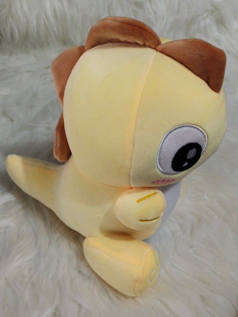 yellow stuffed dinosaur