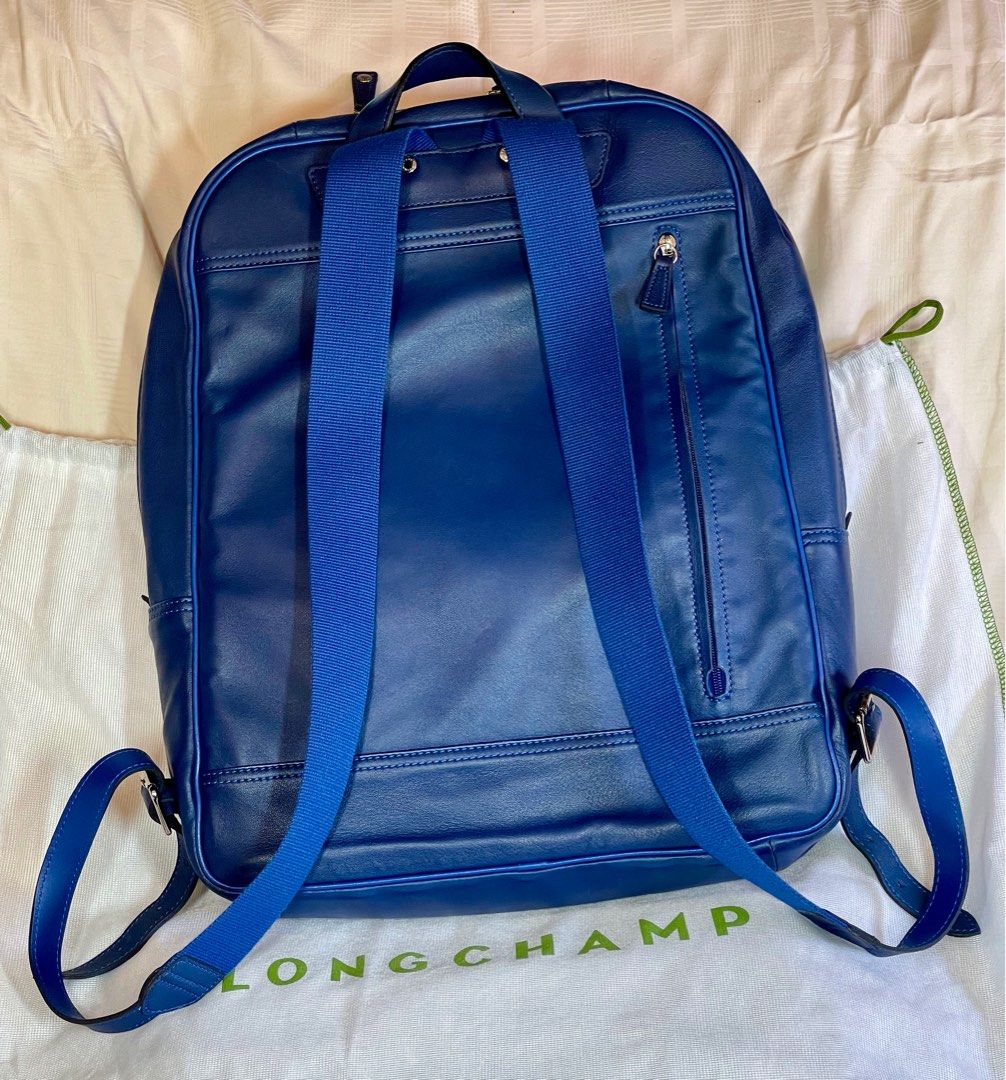 Original Longchamp Leather Backpack (Category: Backpacks) located in Muntinlupa City. Submitted by 300steps (Listing ID 1198970106, Image 2). Description: Preowned beautiful royal blue leather unisex backpack Well-cared for and never set on the ground Barely perceptible signs of wear 2 zippered outer pockets (front and back) 1 zippered front pouch with inner pockets 1 zippered large inner pocket 2 internal tablet/laptop sleeves.